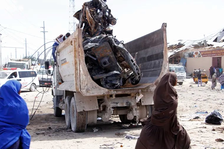 A truck carries wreckage of a car used in a car bomb in Mogadishu, Somalia, Saturday, Dec. 28, 2019. A truck bomb exploded at a busy security checkpoint in Somalia's capital Saturday morning, authorities said. It was one of the deadliest attacks in Mogadishu in recent memory.