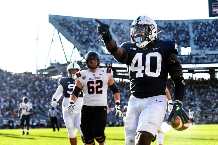 Penn State linebacker Jesse Luketa (40) celebrates after intercepting Ball State quarterback Drew Plitt (9) and returning it for a touchdown in the third quarter in State College, Pa., on Saturday, Sept. 11, 2021. Penn State defeated Ball State, 44-13.