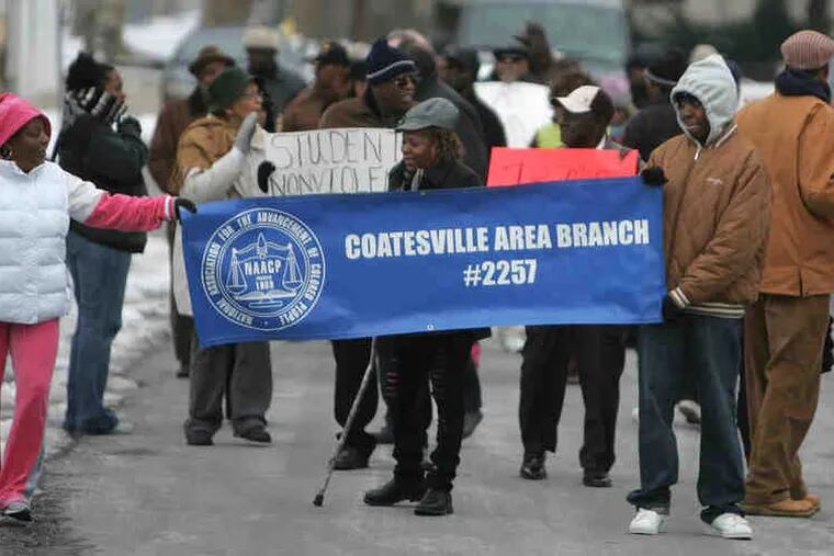 Several dozen marchers assemble for the symbolic walk through Coatesville.
