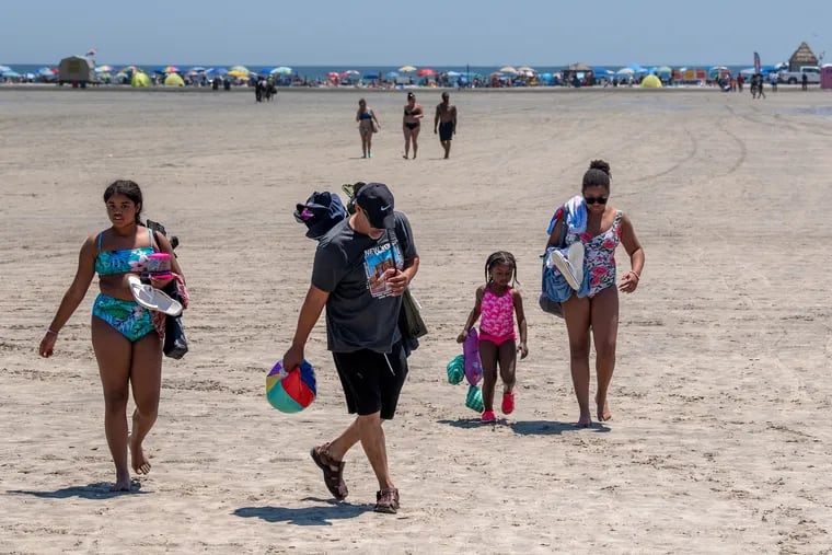 A family heading toward the Boardwalk from the Wildwood beach last summer.
