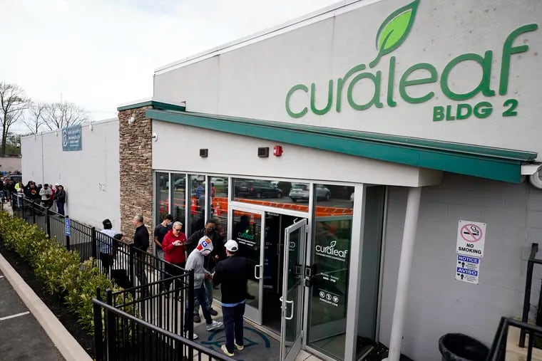 In a file photo, customers enter a Curaleaf dispensary in Bellmawr, N.J. A former employee of a South Philadelphia Curaleaf filed a  lawsuit against the company, accusing it of violating the city's Fair Workweek Law.