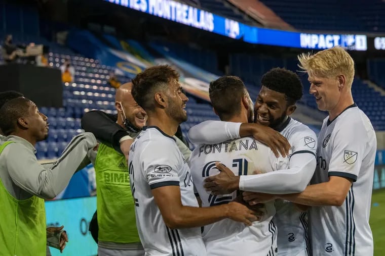 Anthony Fontana (21) gets a hug from Mark McKenzie and celebrates with other teammates after scoring a goal in the Union's 4-1 win over the Montreal Impact on Sunday.