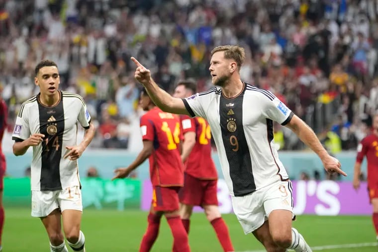 Niclas Füllkrug (right) celebrates his goal against Spain that kept Germany alive in the World Cup.