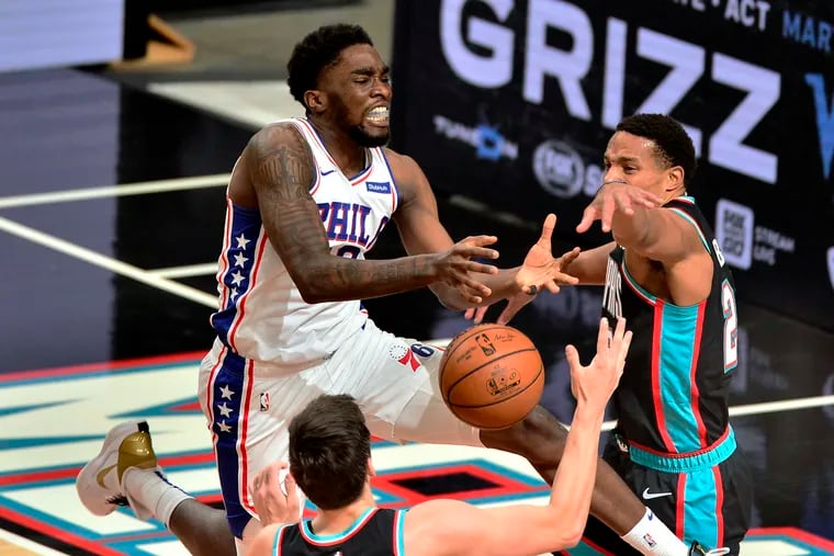 Philadelphia 76ers guard Shake Milton, left, loses control of the ball against Memphis Grizzlies guard Desmond Bane, right, in the second half of an NBA basketball game Saturday, Jan. 16, 2021, in Memphis, Tenn.