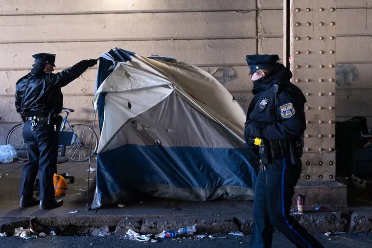 Philadelphia Police check tents to make sure there are no people in them at the Emerald Street encampment, which was being cleared out, today in Kensington, Philadelphia,  January 31, 2019.