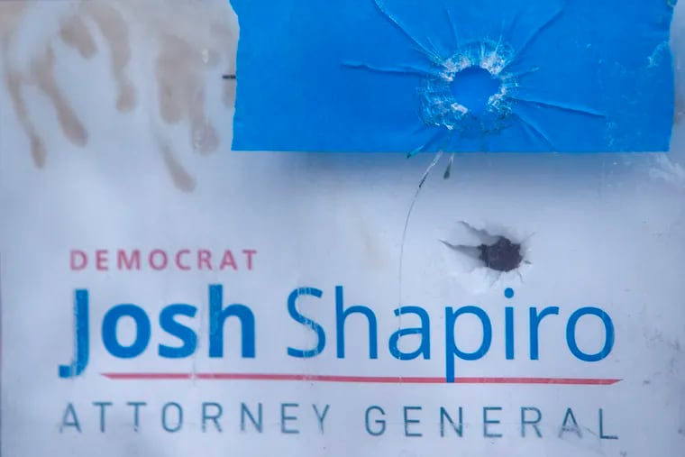 Bullet holes in the windows of the Montgomery County Democratic Committee in Norristown. One went though political poster for Democrat Josh Shapiro for Attorney General.
