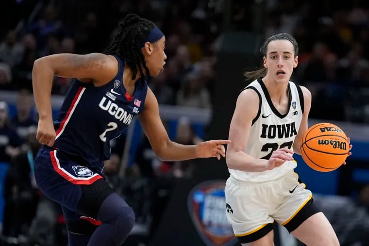 Iowa's Caitlin Clark (right) drives past UConn's KK Arnold during the second half.