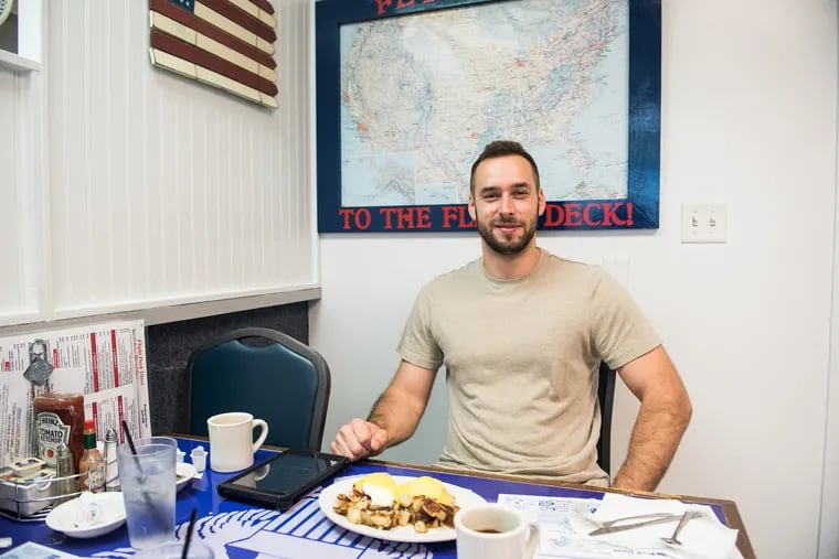 Tiberiu Szabo sits down to a plate of eggs Benedict and a coffee at the Flight Deck Diner. It's a less than $10 meal that will cost him over $100 when flight costs are included. 