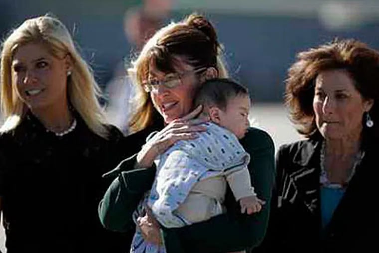 Republican Vice Presidential candidate Sarah Palin and her son, Trig, at the Philadelphia International Airport. Columnist John Baer says readers let him know he made an insensitive comment when describing the boy. (Laurence Kesterson / Staff Photographer / File)