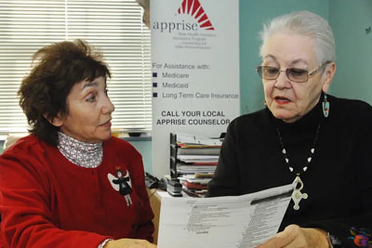 Bette Ferrill (left), 67, of Havertown listens to prescription options available to her from Apprise coordinator Kim Andrews at the Friendship Circle Senior Center in Darby.