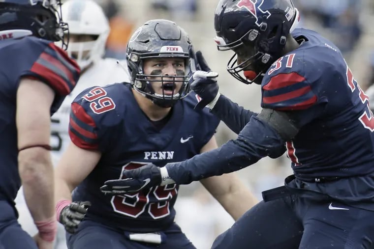 Penn 99 Cooper Gardner looks to teammate # 31 Benji Mowatt who celebrates after sacking Columbia quarterback Josh Bean with under 2 minutes to go in the Columbia at University of Penn football game at Franklin Field in Phila., Pa. on October 13, 2018. Penn won the game 13-10. ELIZABETH ROBERTSON / Staff Photographer