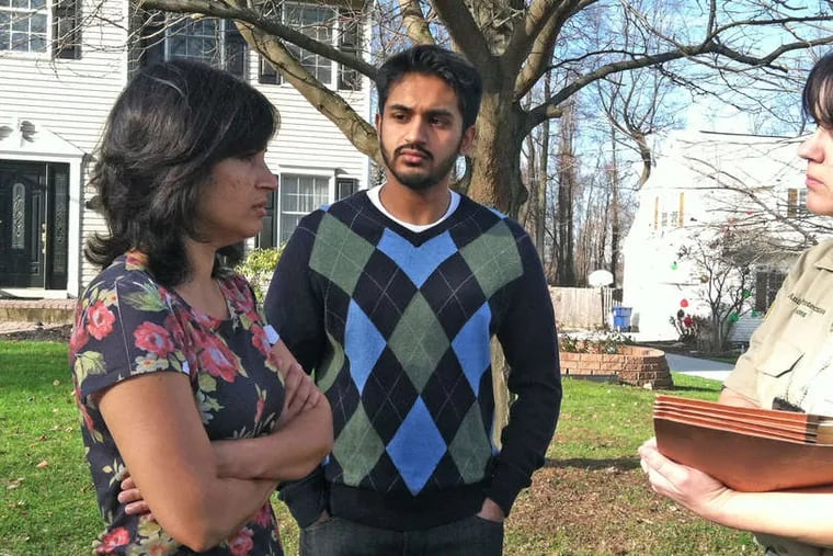 Sabah Qasim and son Asad talk with Cheryl Shaw of the Chester County SPCA. The family's cat, Furball, left, was euthanized because of injuries.