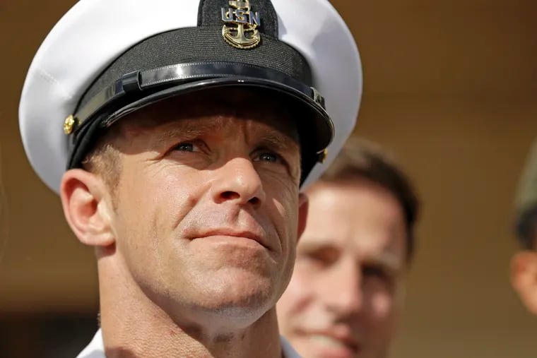 In this July 2, 2019, file photo, Navy Special Operations Chief Edward Gallagher leaves a military court on Naval Base San Diego. The war crimes case against the Navy SEAL not only cost the Navy secretary his job. It dragged an elite military force whose ethos calls for its warriors to be quiet professionals into a very public and divisive political firestorm.
