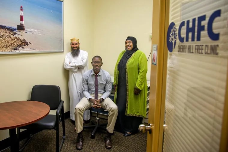 In an examination room are (from left) John Starling, mosque executive director; Jubril Oyeyemi, clinic medical director; and Rashidah Khalifa, operations manager.