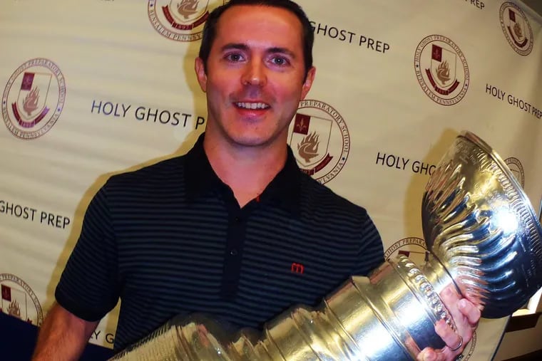 Jim Britt, the director of team operations for the Pittsburgh Penguins, shows off the Stanley Cup at Holy Ghost Prep on Monday.