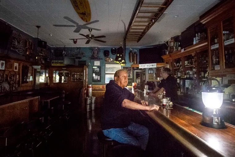 Joseph Pokorski drinks a beer at The Town Square as downtown Sonoma, Calif., remains without power on Wednesday, Oct. 9, 2019. Pacific Gas and Electric has cut power to more than half a million customers in Northern California hoping to prevent wildfires during dry, windy weather throughout the region.