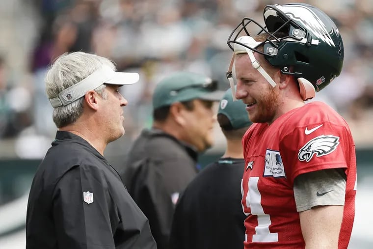 Eagles head coach Doug Pederson talks to quarterback Carson Wentz during a open practice at Lincoln Financial Field in South Philadelphia on Saturday, August 11, 2018. YONG KIM / Staff Photographer
