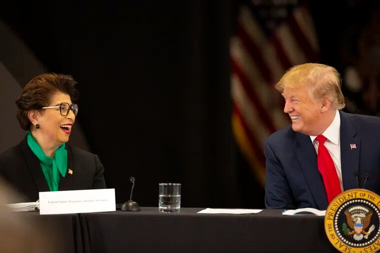President Donald Trump jokes with United States Treasurer Jovita Carranza at Nuss Truck and Equipment Monday, April 15, 2019, in Burnsville, Minn.