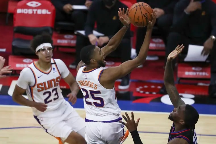 Phoenix Suns forward Mikal Bridges drives to the basket against the Sixers.