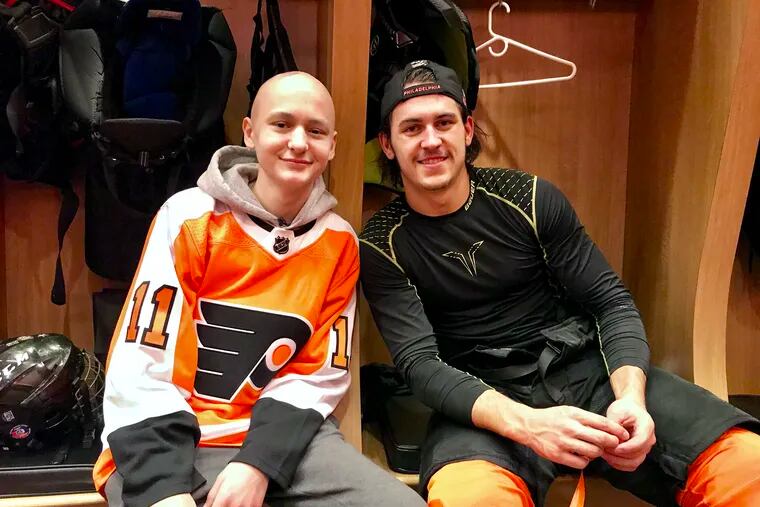 14-year-old Zach Steward (left) shares a moment with his favorite player, Flyers winger Travis Konecny.