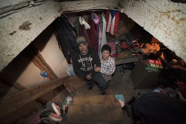 Jurabe Arroyo with his wife, Irma Cabrera are photographed in the basement of a home in North Philadelphia. Wednesday, Feb. 07, 2018. Juarbe Arroyo and his family lost everything in Hurricane Maria– their house, car and most belongings. They moved to Philadelphia where a relative offered her basement as temporary housing. They’ve been living in this basement for three months now and struggling to get a place of their own without any FEMA assistance.JOSE F. MORENO / Staff Photographer
