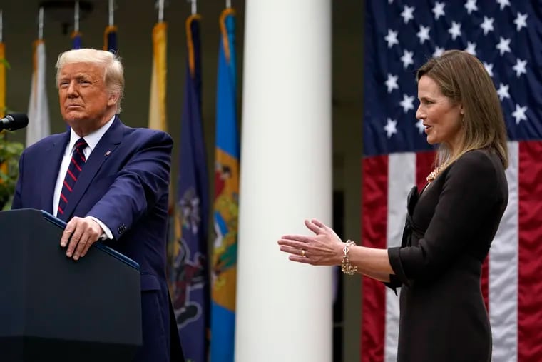 Judge Amy Coney Barrett applauds as President Donald Trump announces Barrett as his nominee to the Supreme Court in the Rose Garden at the White House on Saturday.