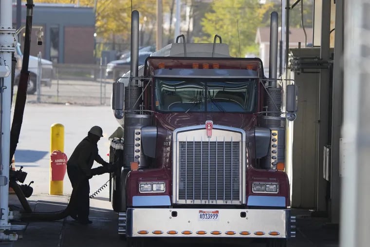 A trucker loads his truck with fuel at the Marathon Oil Refinery in Salt Lake City, Utah on Oct. 29, 2021. Prices for gasoline are expected to hit $4 a gallon soon and could go higher if Russia holds back on oil and gas shipments. But that is unlikely, Mark Zandi writes, because it would throw even more chaos into a beleaguered Russian economy.  (George Frey/AFP/Getty Images/TNS)