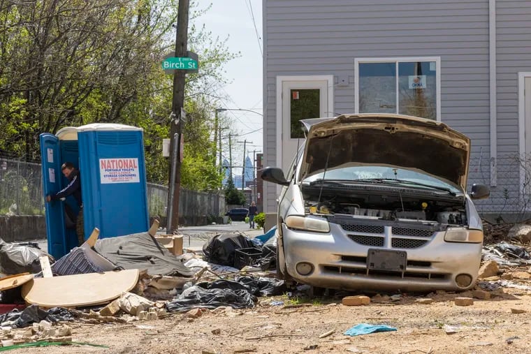 An abandoned minivan dumped in a derelict lot at East Birch and Martha Streets in April