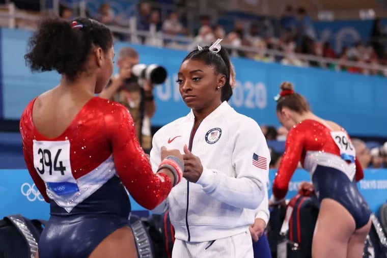 Simone Biles talks with Jordan Chiles of Team United States during the Women's Team Final on day four of the Tokyo 2020 Olympic Games at Ariake Gymnastics Centre on July 27, 2021 in Tokyo, Japan. (Laurence Griffiths/Getty Images/TNS)