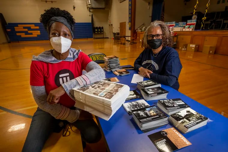 Researcher and genealogist Shamele Jordon (left) and retired teacher Muneerah Higgs with postcards of historic places in Lawnside. These postcards along with other educational information are being packaged for students learning virtually.