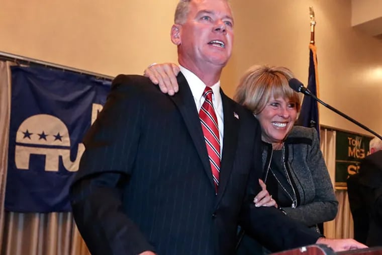 Tom McGarrigle, with wife Michele, thanks supporters at the Springfield Country Club in Delaware County, Tuesday, November 4, 2014. ( Steven M. Falk / Staff Photographer )