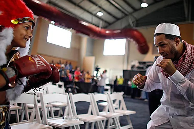Hector Camacho Jr. right, playfully spars with Alexander Birriel, 10, during a memorial for his father, the former boxing champion Hector “Macho” Camacho in San Juan, Puerto Rico. (Ricardo Arduengo/AP)