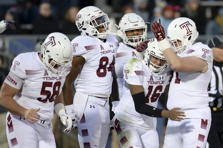 Temple quarterback Todd Centeoi celebrates with teammates during the Owls' rout of UCONN on Saturday.