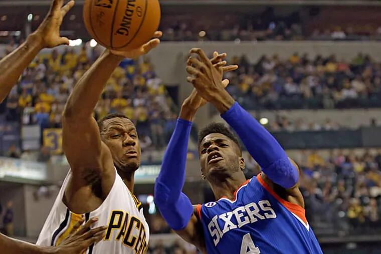 Indiana Pacers forward Lavoy Allen (5) battles for a rebound with Philadelphia 76ers forward Nerlens Noel (4) during the first half of an NBA basketball game in Indianapolis, Wednesday, Oct. 29, 2014. (AJ Mast/AP)