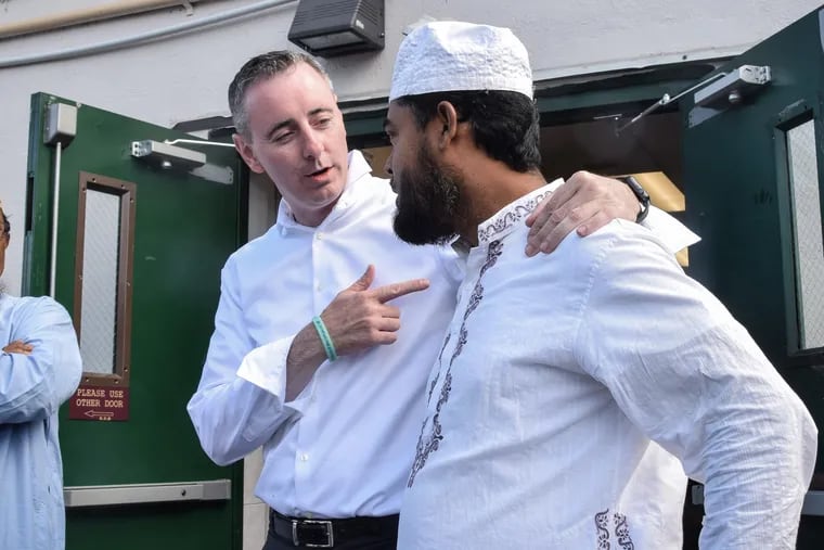 Brian Fitzpatrick speaks to Mohammad Fakrul Islam after attending a prayer service at North Penn Mosque in Lansdale, Pa., earlier this month. Fitzpatrick says he attends prayer services there every week to connect with his constituents.