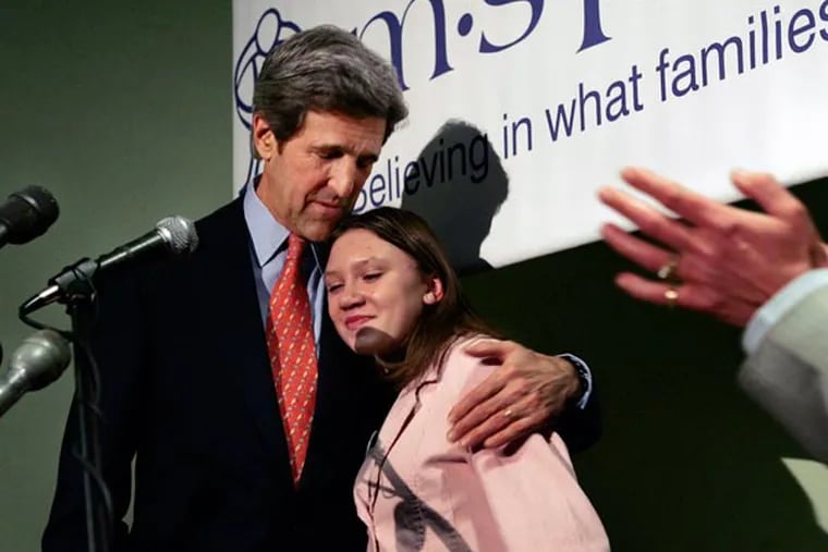 U.S. Sen. John Kerry, D-Mass., hugs 13-year-old abuse survivor Masha Allen after a news conference in Boston Friday, Jan. 6, 2006, where Kerry spoke about legislation he recently introduced that would increase penalties for anyone who downloads child pornography off the Internet. "Masha's Law" is named for Masha Allen, who was adopted from a Russian orphanage at age 5 by an American man who began sexually abusing her and posted hundreds of pornographic images of her on the Internet. (AP Photo/Elise Amendola)