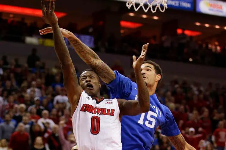 A shot by Louisville's Terry Rozier is blocked by Kentucky's Willie Cauley-Stein. Rozier finished the game with 15 points. &nbsp;&nbsp;&nbsp;MARK CORNELISON / Lexington Herald-Leader