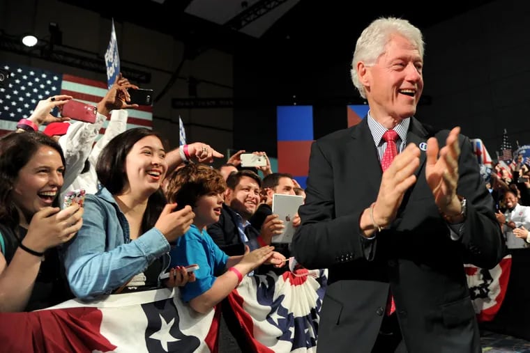 Former President Bill Clinton joins supporters cheering as his wife, Democratic presidential candidate Hillary Clinton, takes the stage at the Convention Center in Philadelphia after winning the Pennsylvania primary on April 26, 2016.