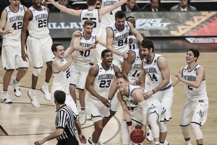 Villanova players storm the court after beating Michigan 79-62 in the NCAA men’s basketball championship game at the Alamodome in San Antonio, Texas.