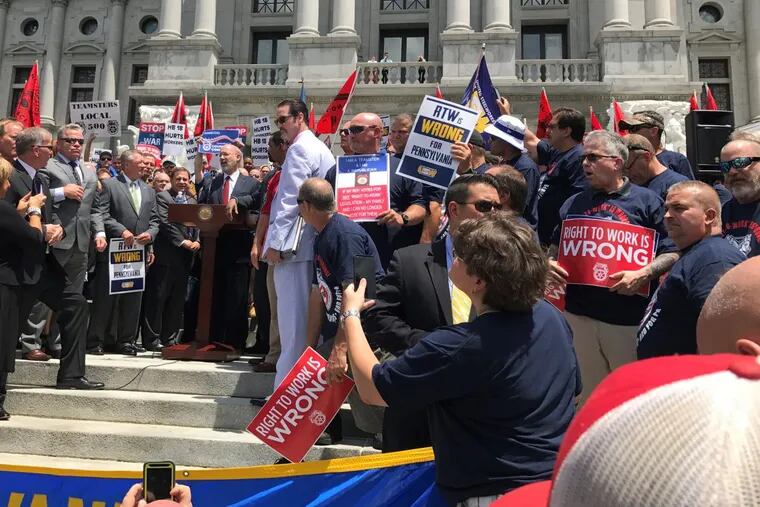 Gov. Wolf speaks to a rally protesting bills that could restrict collective bargaining.