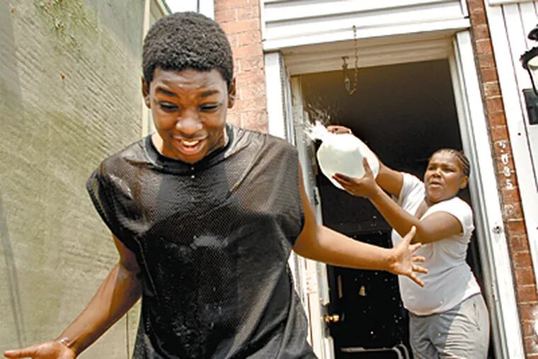Siblings Delores and Dan King, who left New York gang threats to live in Philadelphia, try to keep cool. (Jonathan Wilson/Inquirer)