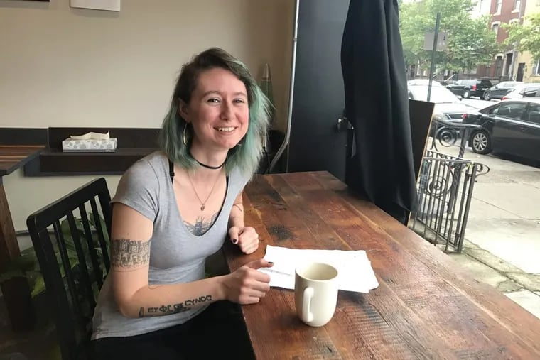 Katy Hanson, 27, of South Philadelphia with her check-list of birthday freebies at Cinemug, a South Philadelphia coffee shop where the barista offered to buy her a coffee for her birthday.
