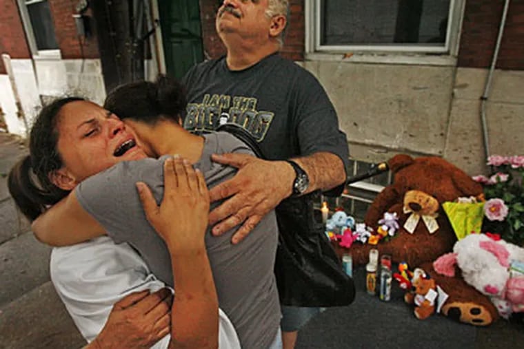 Tammy Rosario (left), mother of Gina Marie Rosario, 7, who was one of three children killed by a car, being consoled by her sister Natalie Elias.  Rosario's uncle Angelo Betancourt, looks to the sky. (Alejandro A. Alvarez / Staff Photographer)