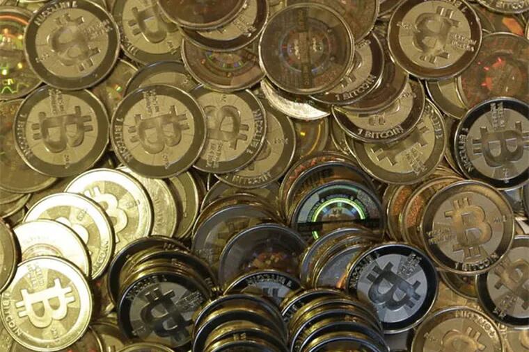 FILE - This April 3, 2013 file photo shows bitcoin tokens in Sandy, Utah.  The Tokyo bitcoin exchange Mt. Gox that filed for bankruptcy protection blamed theft through hacking for its losses Monday, March 3, 2014, and said it was looking into a criminal complaint. (AP Photo/Rick Bowmer, File)
