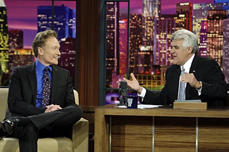 Jay Leno interviews Conan O'Brien in Leno's final taping as host of The Tonight Show. (AP Photo/NBC, Paul Drinkwater)