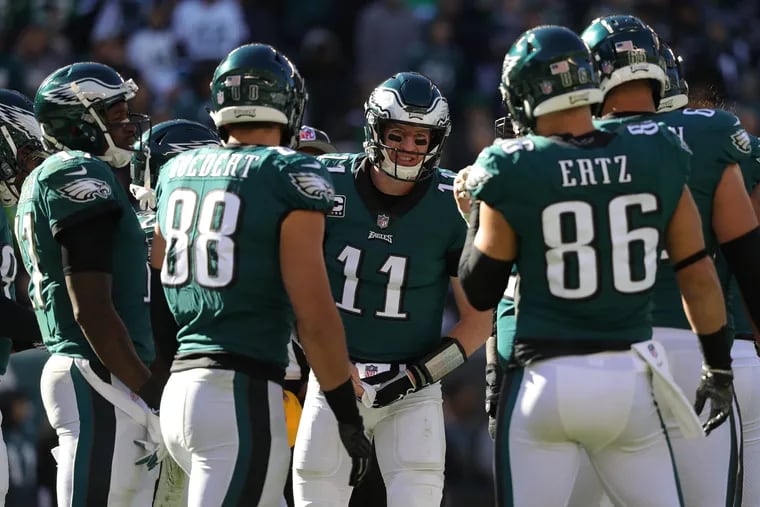 Eagles Carson Wentz, center, gathers with his teammates during a huddle as they play the Panthers. Philadelphia Eagles lose 21-17 to the Carolina Panthers in Philadelphia, PA on October 21, 2018. DAVID MAIALETTI / Staff Photographer