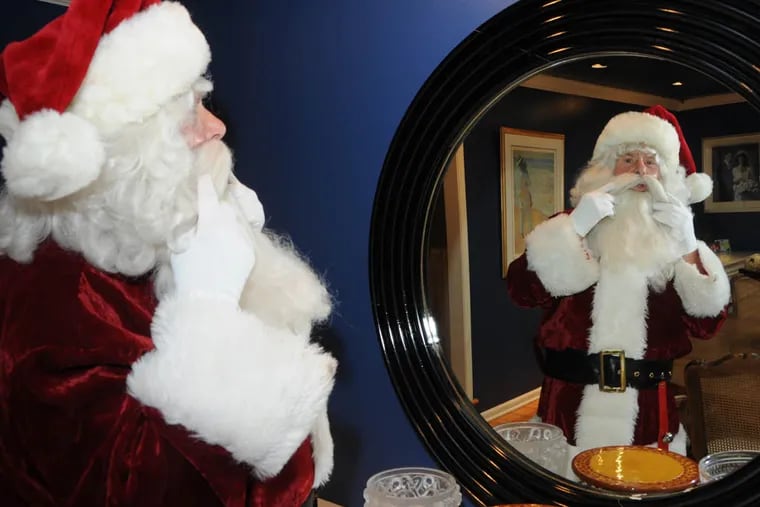 Dr. Joseph Hassman of Cherry Hill gets dressed as Santa Claus. Photo by Curt Hudson