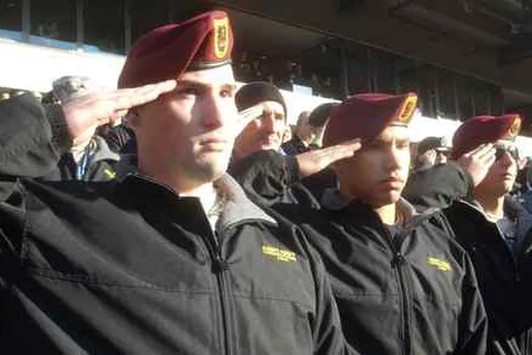 Salutes from soldiers wounded in Afghanistan: Pfc. James Beyer (left), Pvt. Matt Katka (center), and Pvt. Sean Beaver during the national anthem at the Linc before the Army-Navy game. &quot;We remember you every day,&quot; said Adm. Mike Mullen, chairman of the Joint Chiefs.
