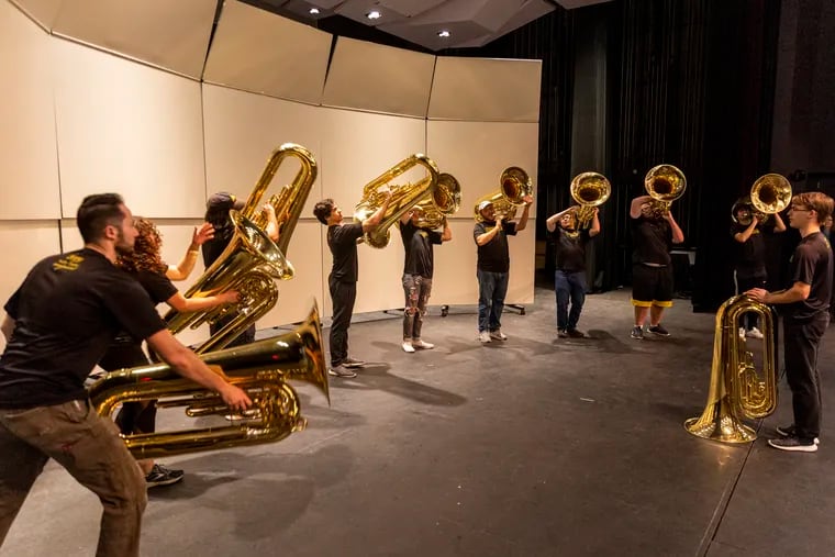Members of the West Chester University band's tuba section practice at the Wells School of Music at West Chester University in West Chester on Dec. 6.