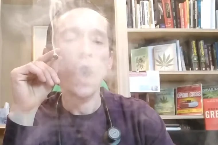 Matthew Roman, an Old City physician, smokes a joint during a live stream he posted to YouTube. The doctor's license to practice medicine was revoked by the state on Apr. 17, 2019.